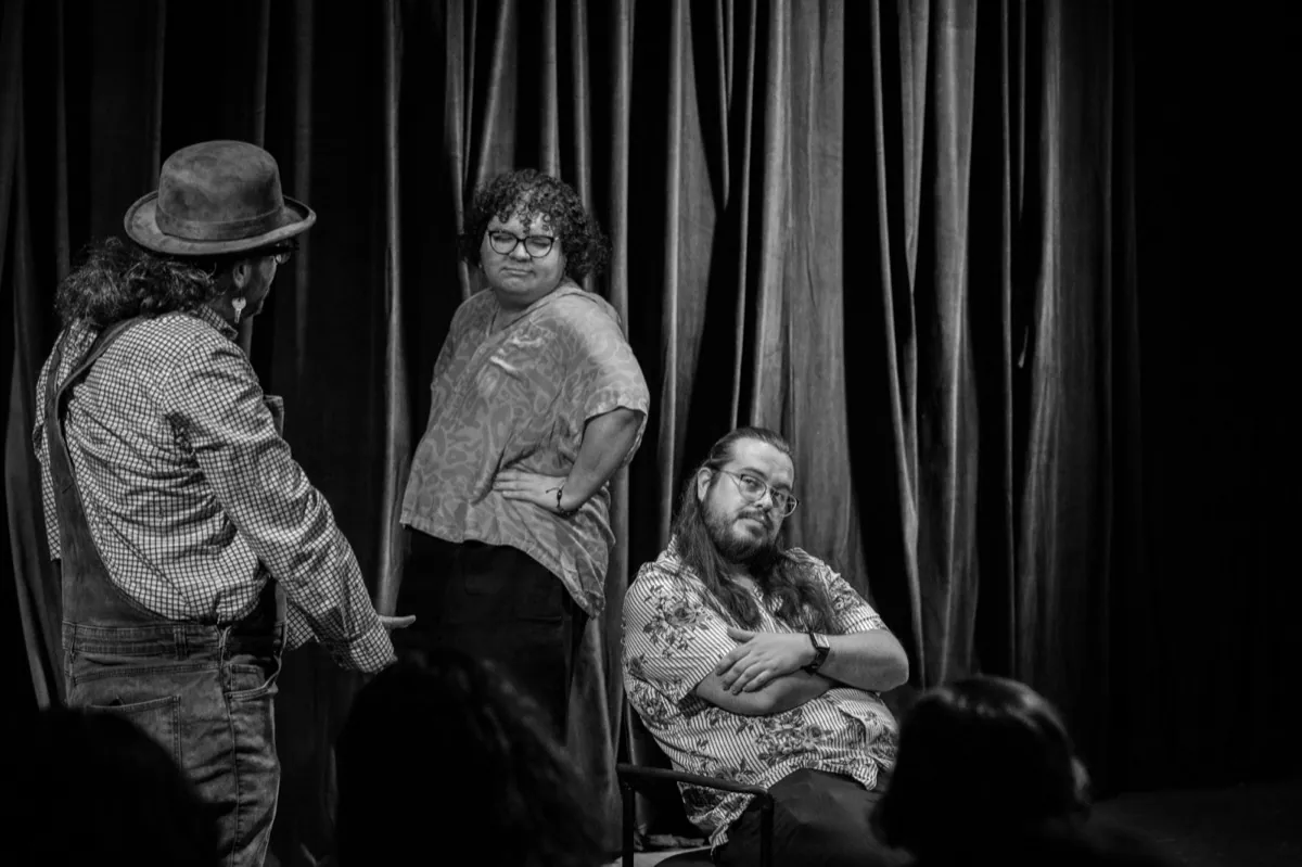 Three performers mid-scene at a Bilingual Improv School workshop