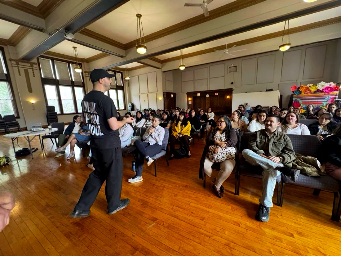 Rudy Mendoza leading a bilingual improv workshop at the Enlace Chicago all-staff meeting